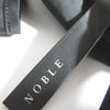 NOBLE JAPAN. 24SS COLLECTION. Black Taffeta Back Open Peplum Blouse